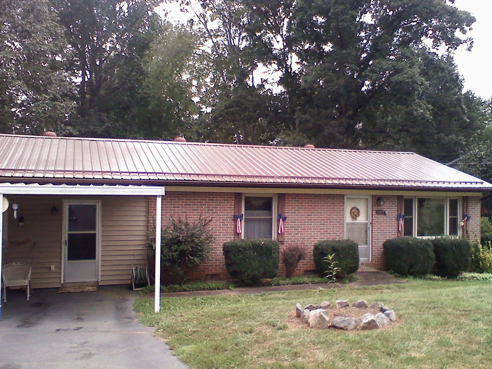 Bronze metal roof and carport on a brick ranch home — Roof Repair work by our crew in Tallmadge